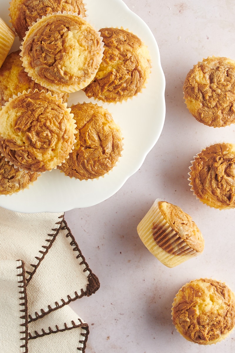 Plate of Biscoff cupcakes with some cupcakes on tabletop