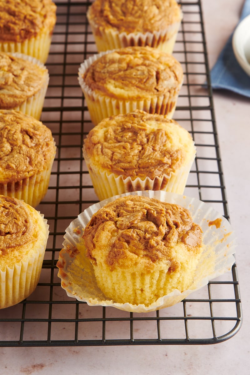 Biscoff cupcakes on cooling wrap with one loosened from wrapper