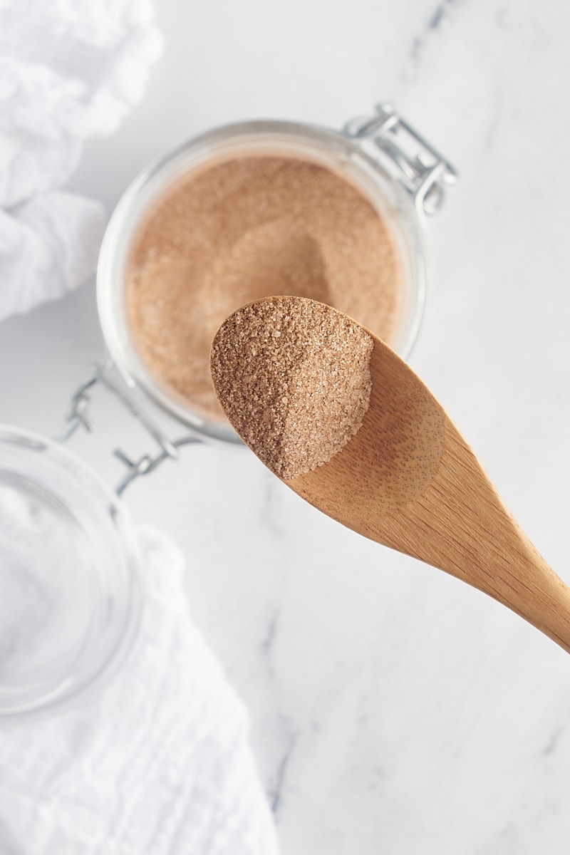 overhead view of cinnamon sugar on a small wooden spoon