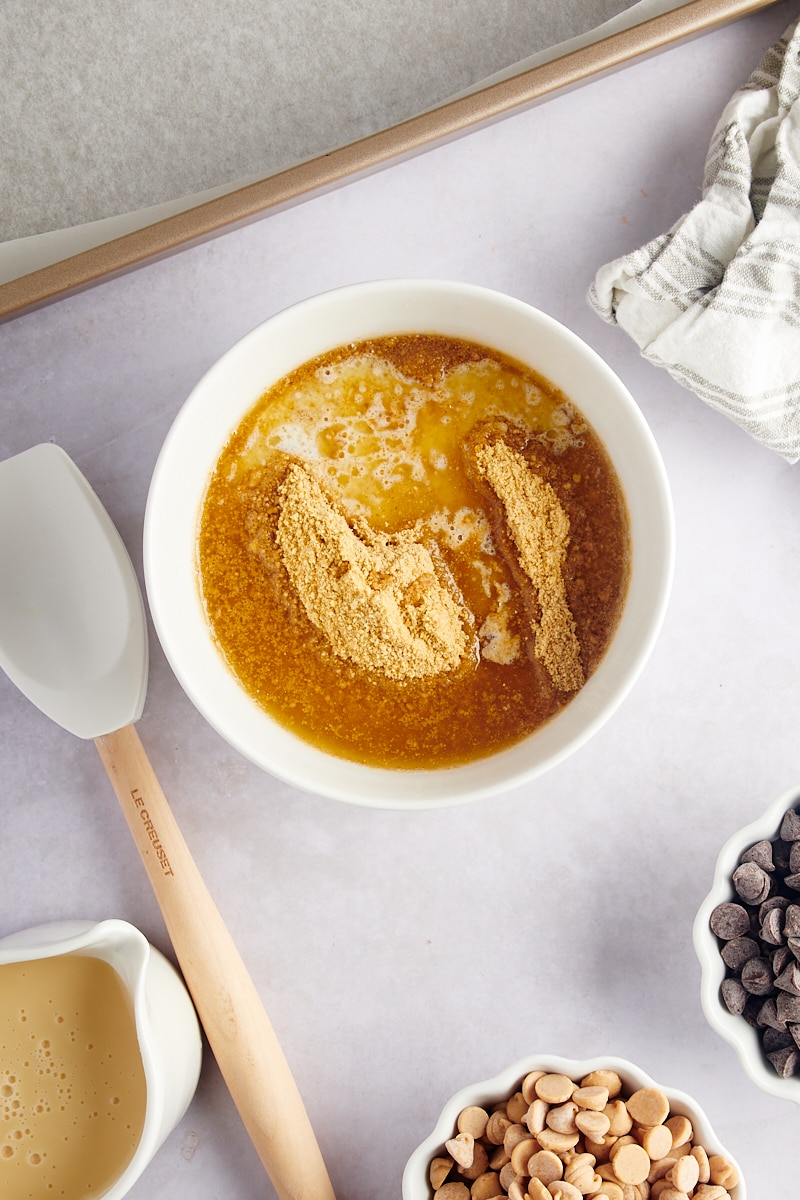 Overhead view of graham cracker crumbs and butter in bowl