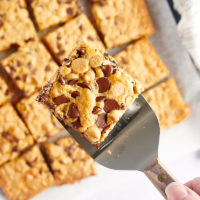 Spatula holding cookie bar over pan