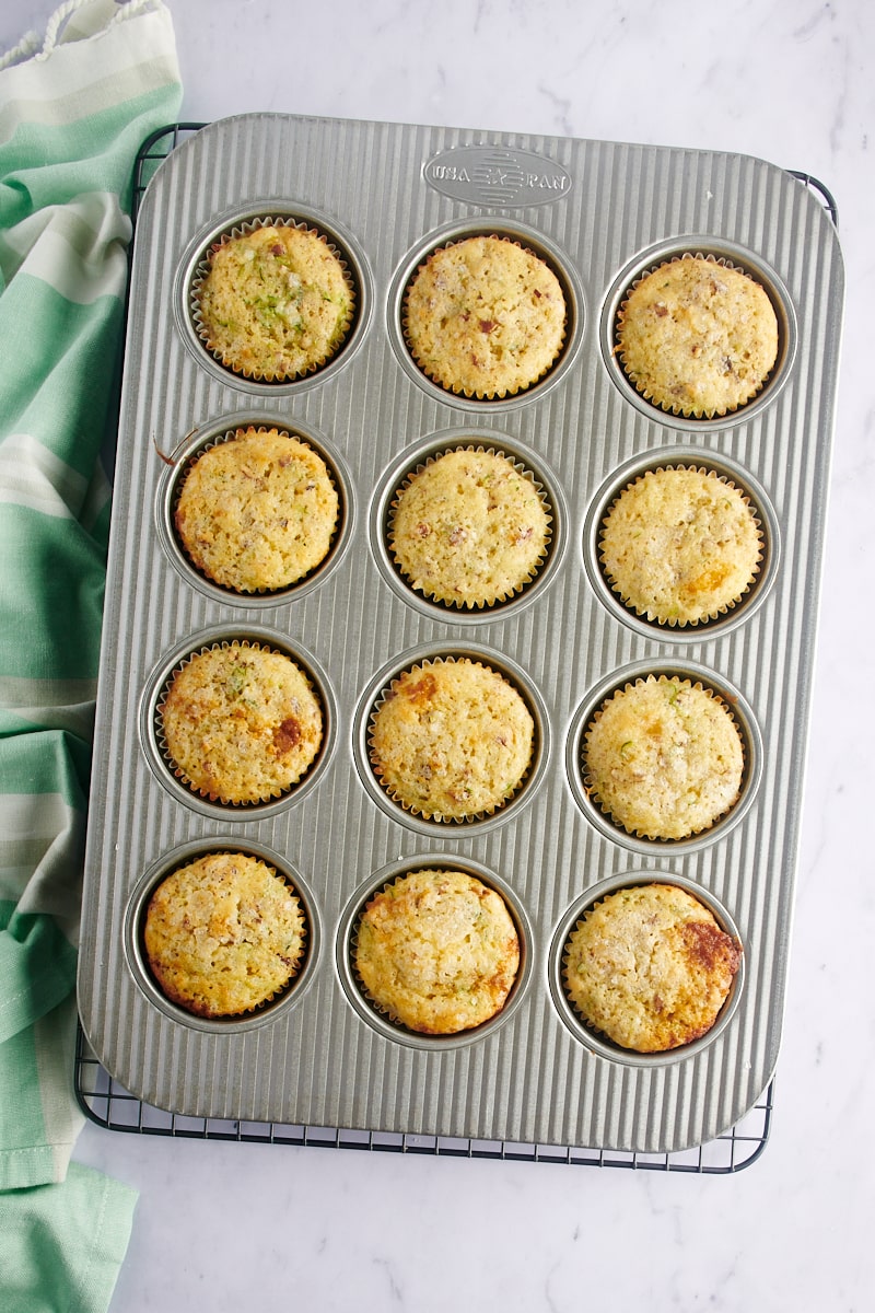 Draufsicht auf frisch gebackene Zitronen-Zucchini-Muffins in einer Muffinform