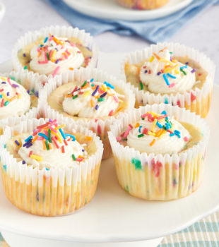 Mini Funfetti Cheesecakes on a white pedestal