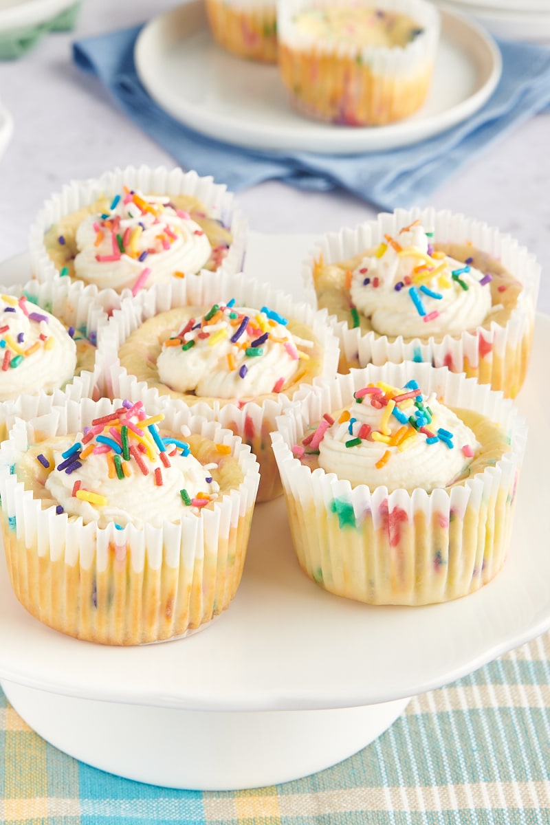 Mini Funfetti Cheesecakes on a white pedestal