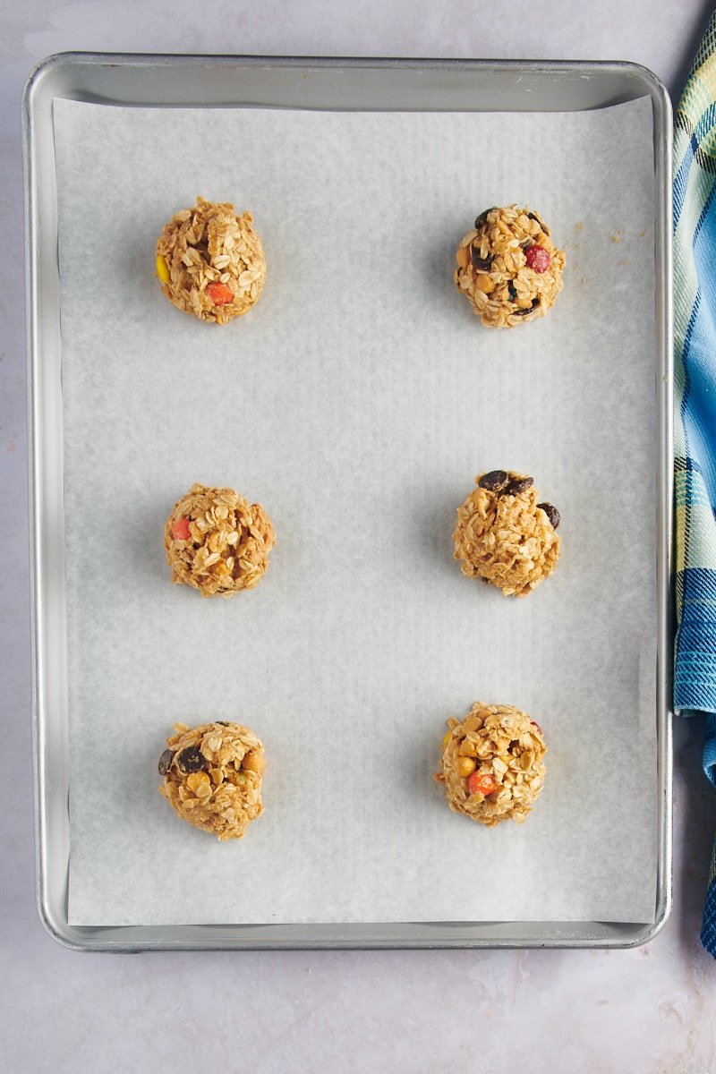 Overhead view of cookie dough balls on baking sheet