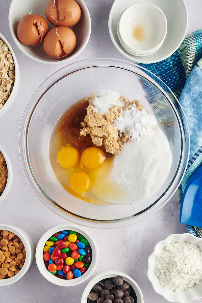 Overhead view of sugar and eggs in a mixing bowl.