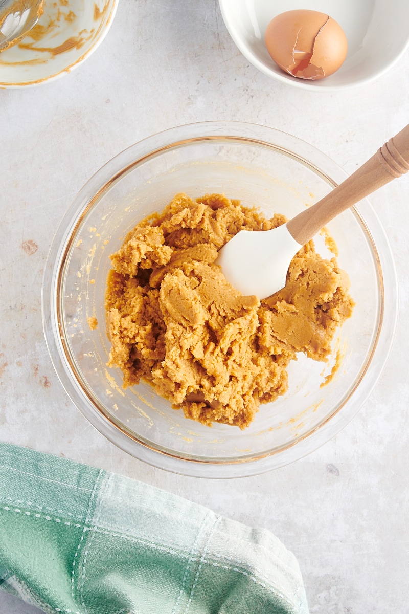 overhead view of mixed 3-Ingredient Peanut Butter Cookie dough in a glass mixing bowl