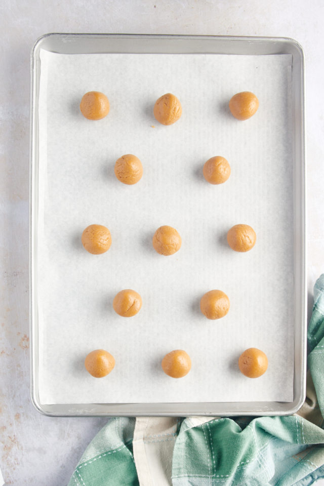 overhead view of portioned 3-Ingredient Peanut Butter Cookies on a baking sheet