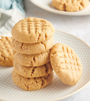 stack of 3-Ingredient Peanut Butter Cookies on a white and beige plate