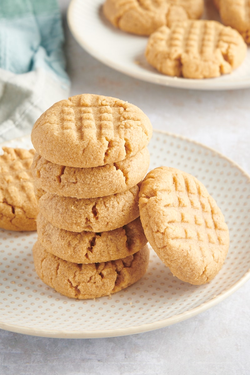 stack of 3-Ingredient Peanut Butter Cookies on a white and beige plate