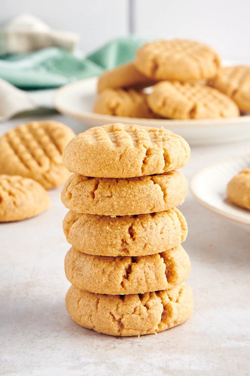 stack of five peanut butter cookies with more cookies in the background