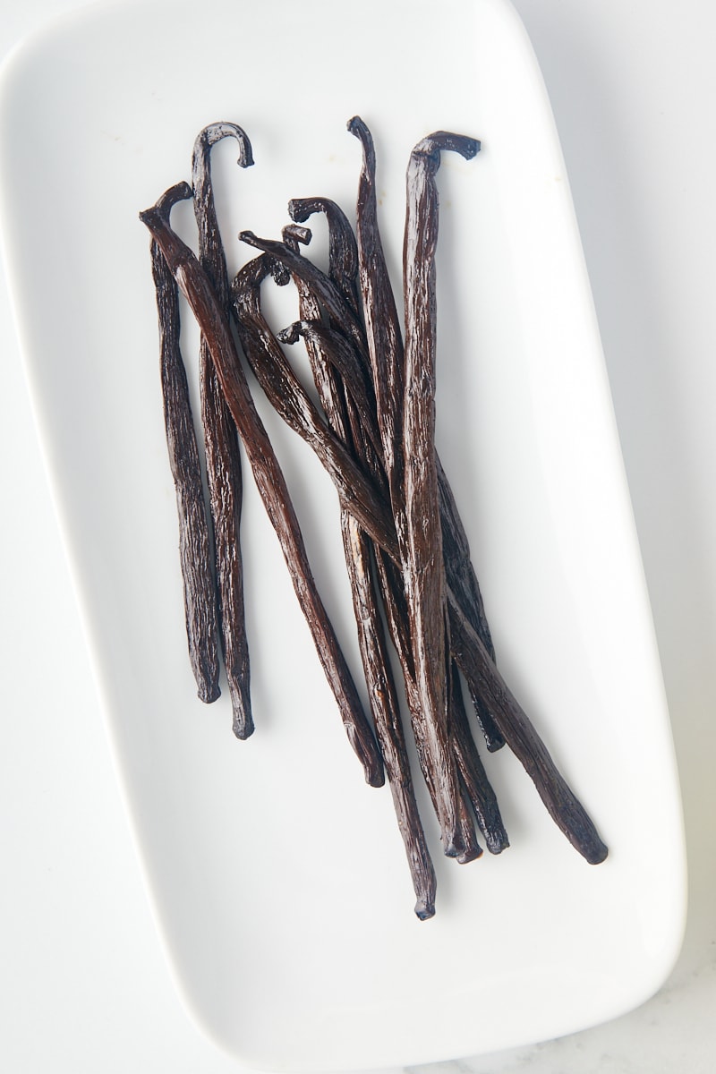 overhead view of vanilla beans on a long white plate