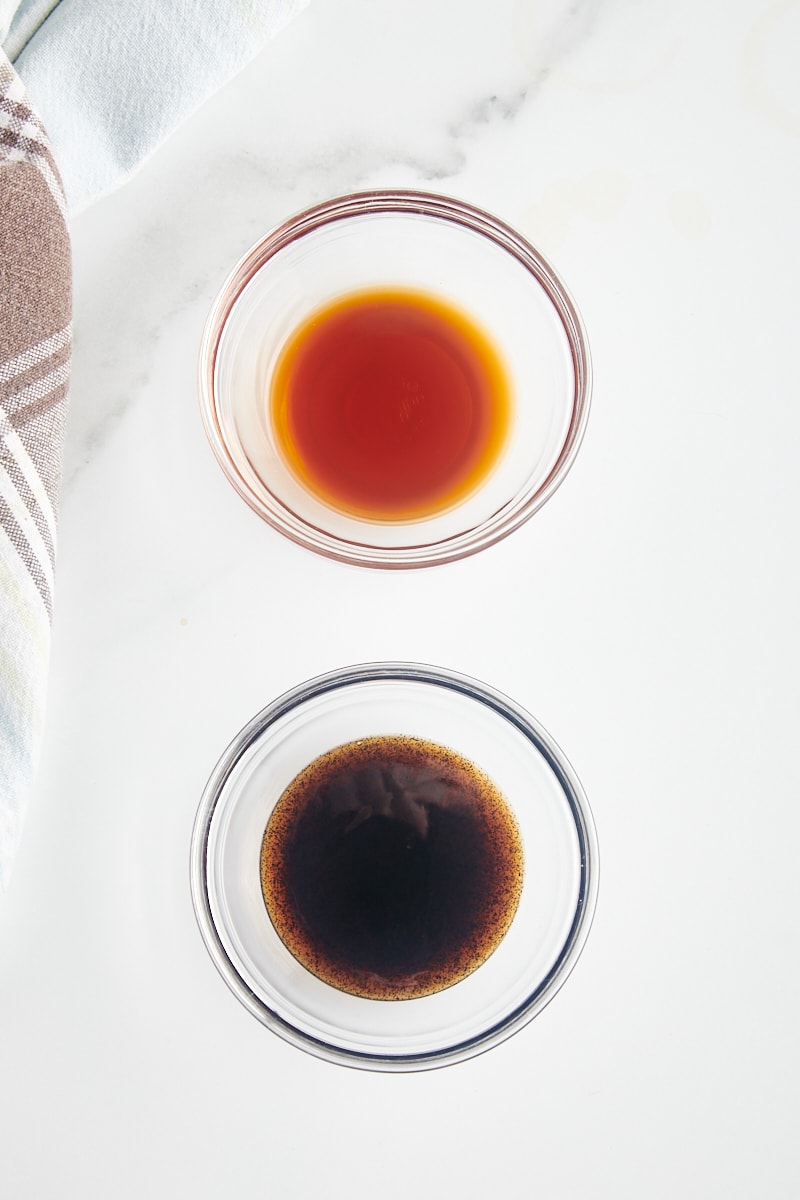 overhead view of vanilla extract and vanilla bean paste in glass bowls