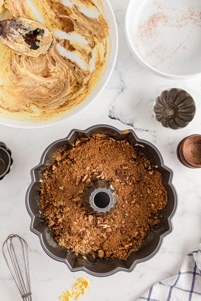 The cinnamon filling on top of the first cake layer in a cinnamon Bundt cake.