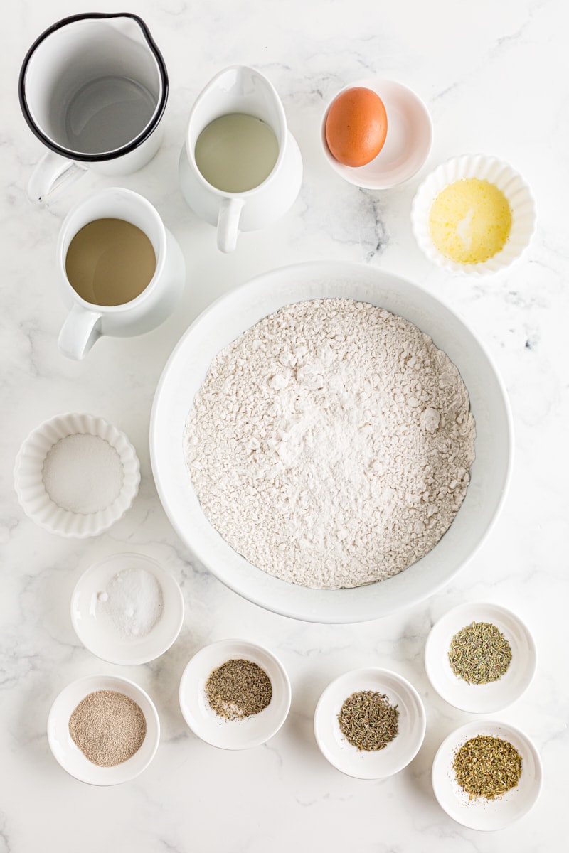 All of the ingredients for Herb Cloverleaf Rolls laid out on the counter.