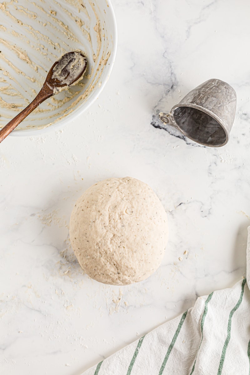 Bread dough rolled into a sphere on the counter.