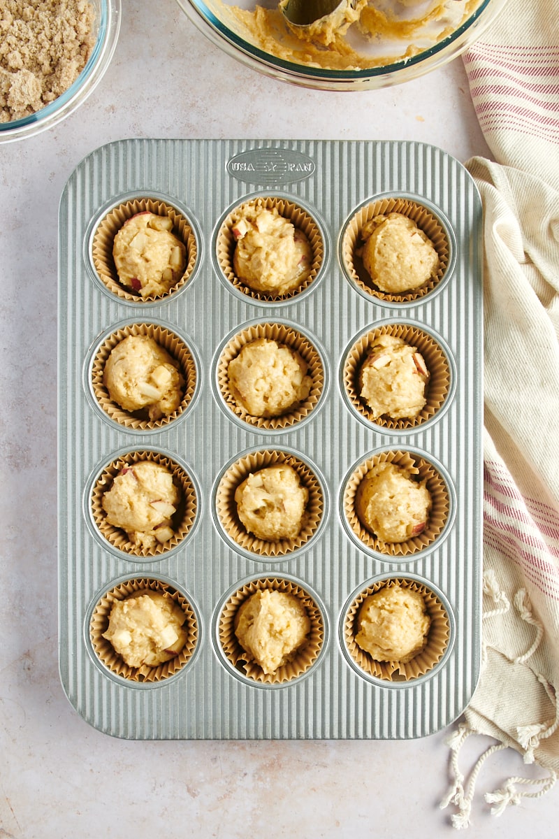 overhead view of Apple Cinnamon Muffin batter in a 12-cup muffin pan