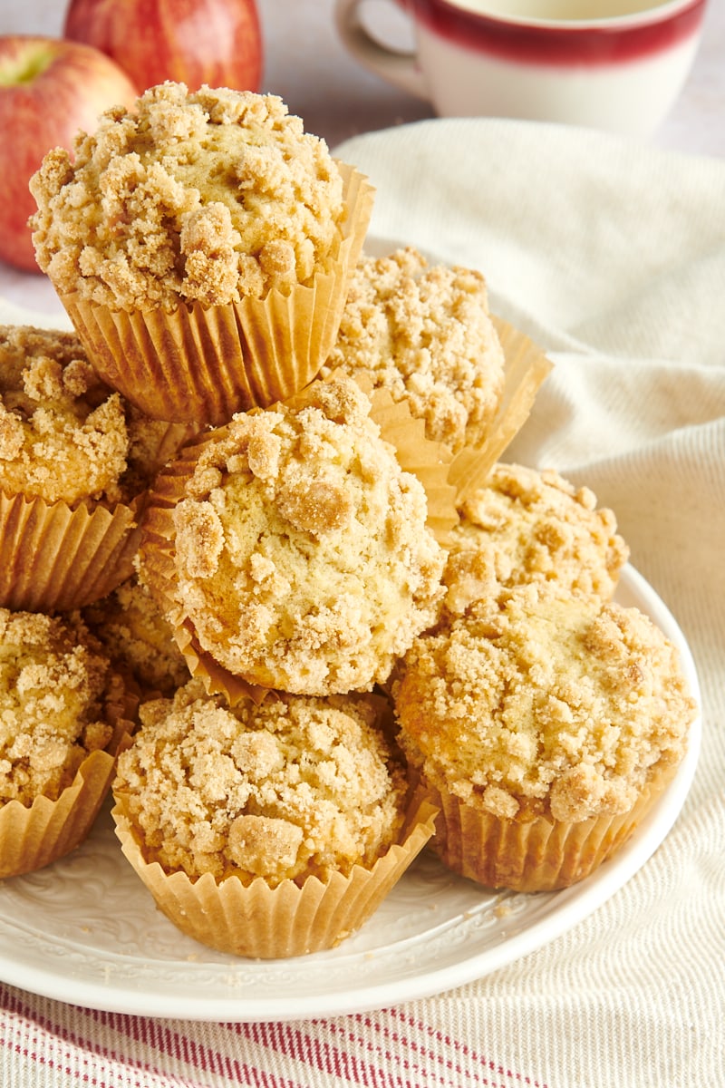 Apple Cinnamon Muffins piled on a white plate