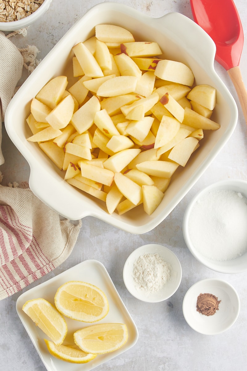 A baking pan full of apple wedges cut in half.