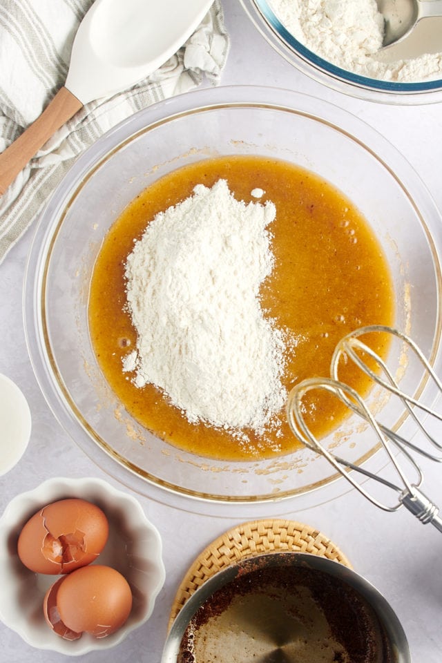 The wet and dry ingredients for chocolate chip cookies being mixed together.