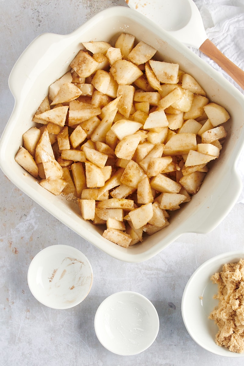 overhead view of mixed Brown Butter Pear Crisp filling in a white baking dish
