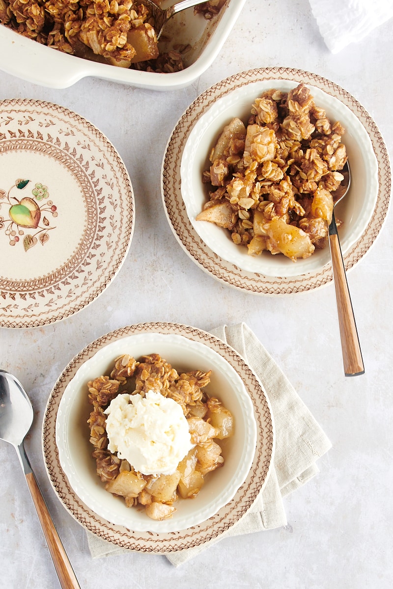 overhead view of two servings of Brown Butter Pear Crisp in white bowls