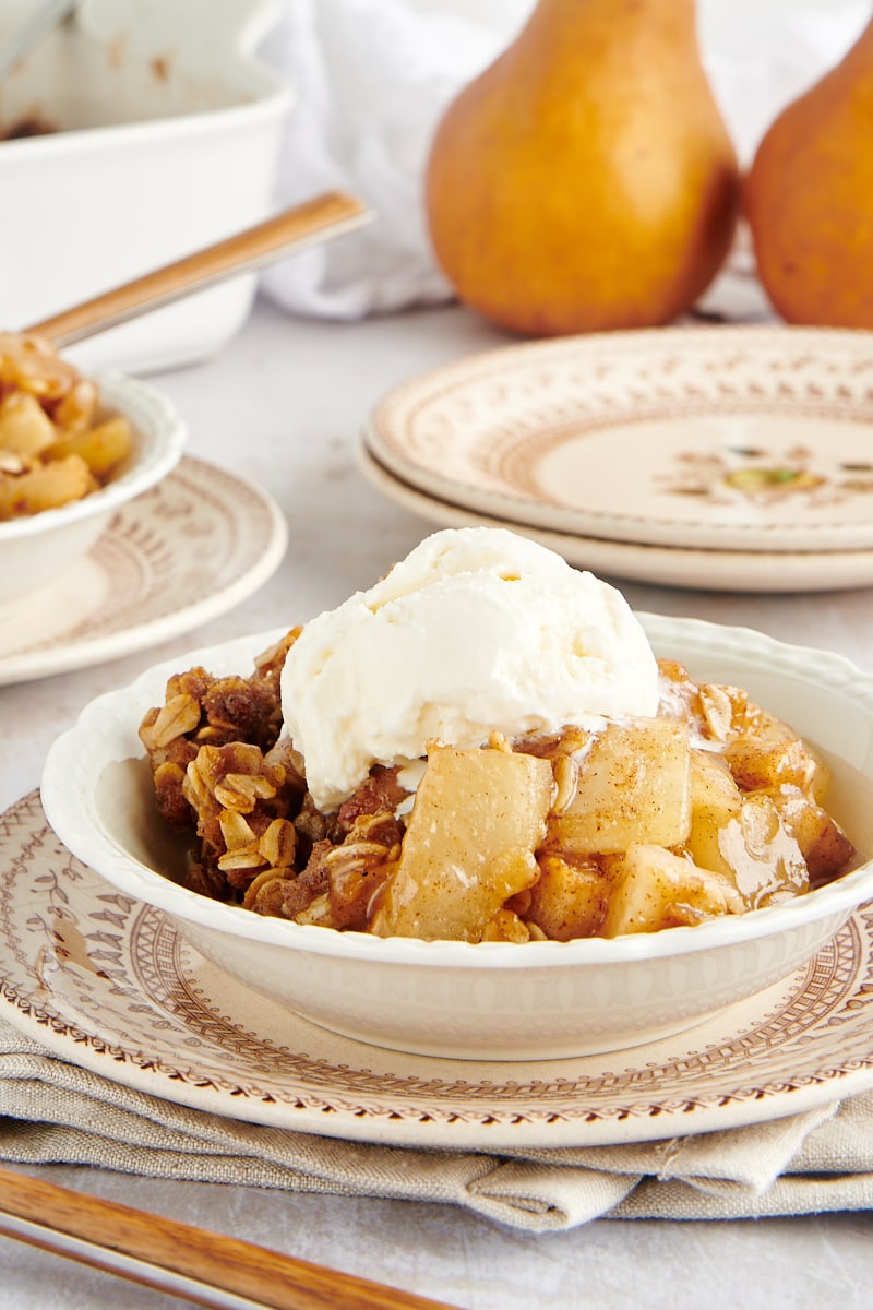 bowl of Brown Butter Pear Crisp topped with ice cream