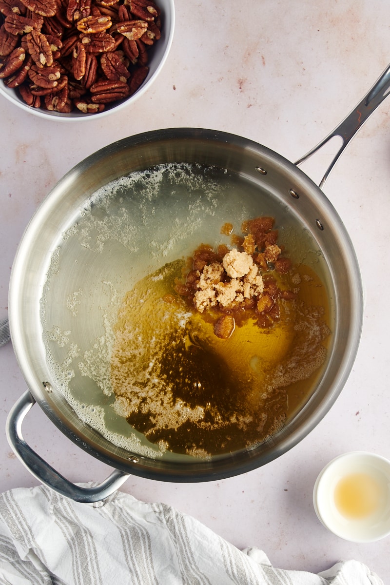 overhead view of butter, brown sugar, maple syrup, and salt in a skillet