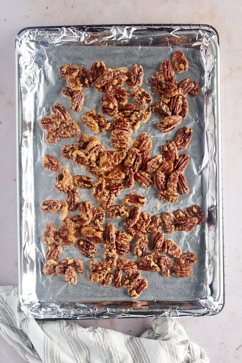 overhead view of freshly toasted Glazed Pecans on a foil-lined baking sheet