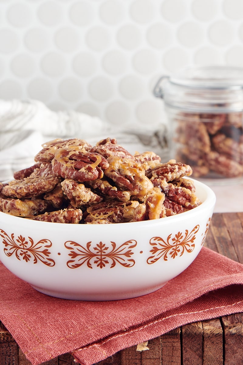 side view of Glazed Pecans in a white bowl