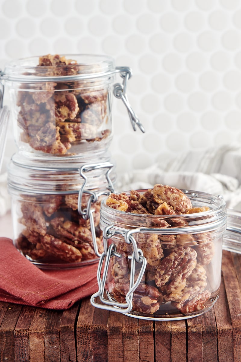 three glass jars filled with Glazed Pecans