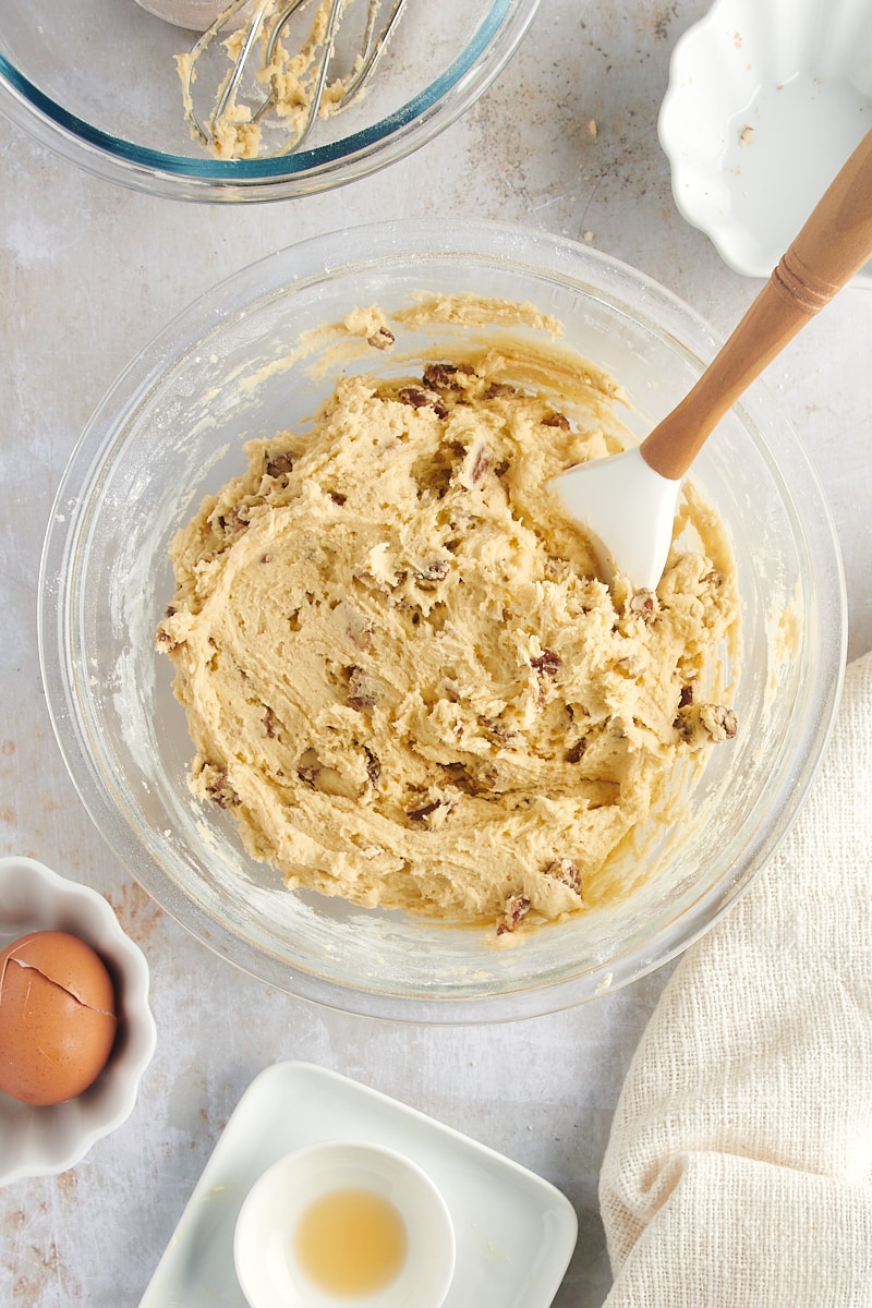 overhead view of mixed Maple Pecan Cookie dough in a glass mixing bowl