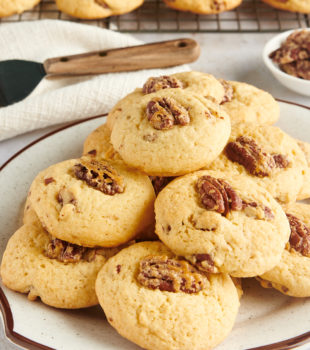 Maple Pecan Cookies stacked on a white and brown-speckled plate