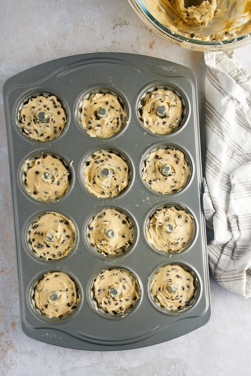 overhead view of chocolate chip cake batter in a mini Bundt pan