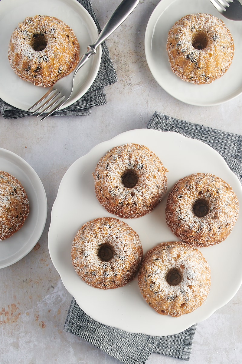 overhead view of Mini Chocolate Chip Bundt Cakes on a white cake stand and small white plates