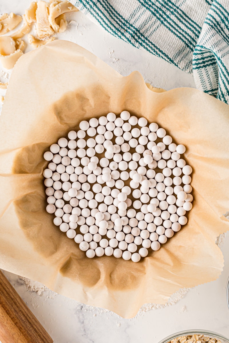 overhead view of pie weights in a pie crust