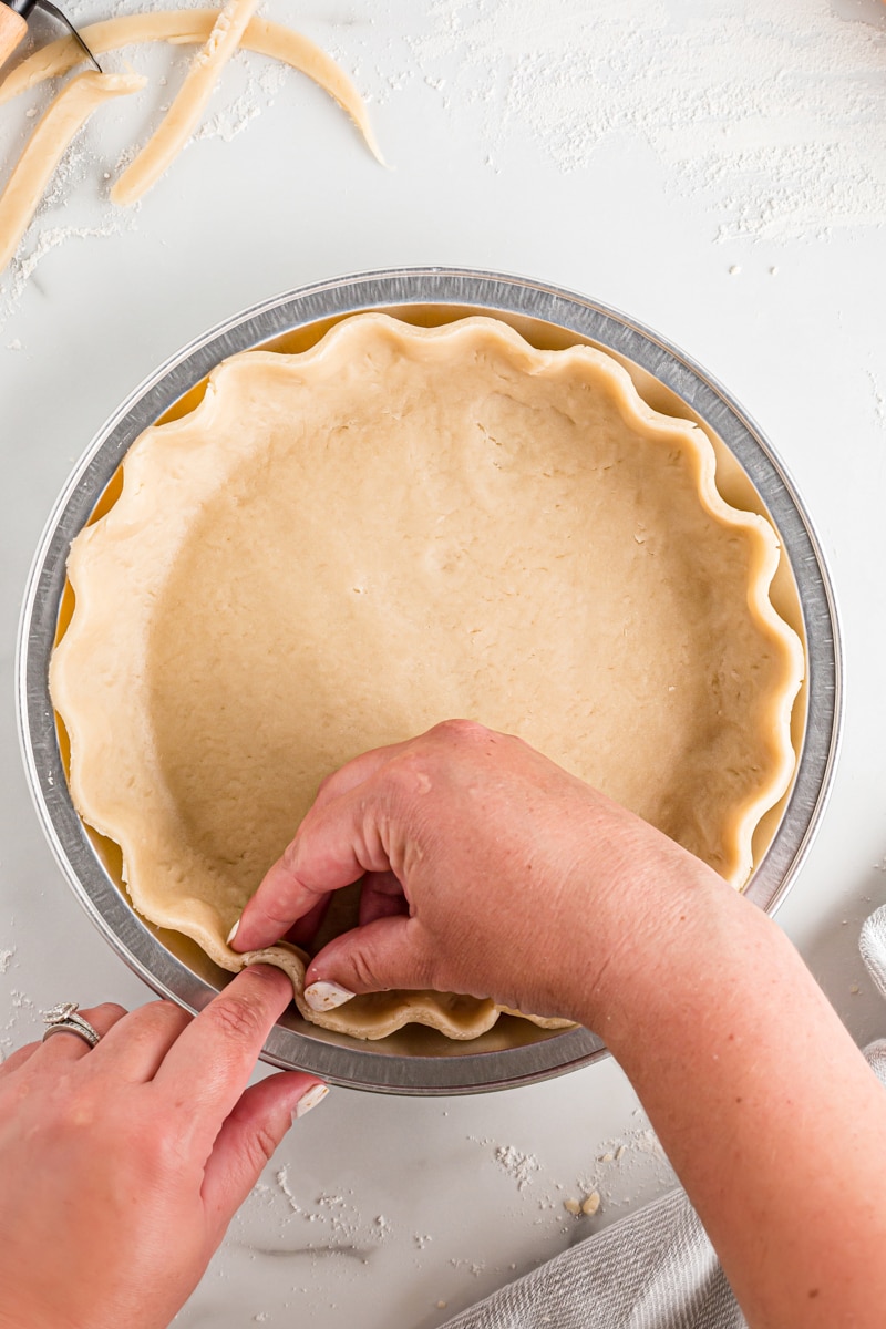 overhead view of making a fluted pie crust edge