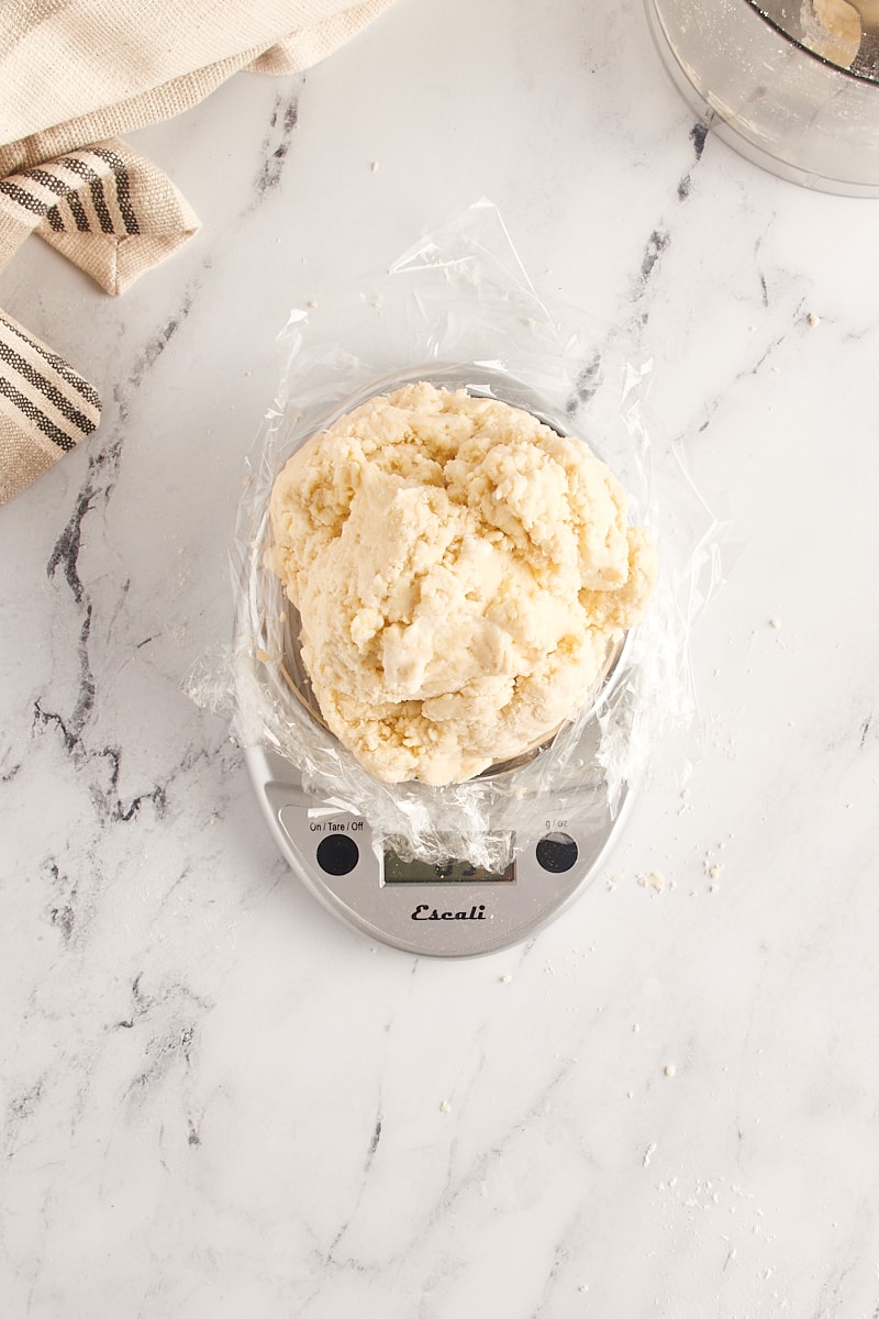 overhead view of pie crust dough on a digital kitchen scale