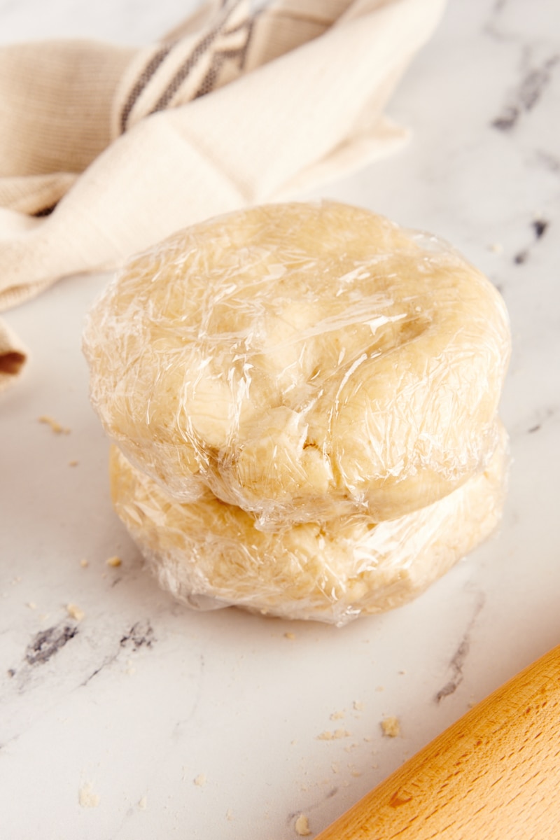 stack of two plastic-wrapped pie crusts