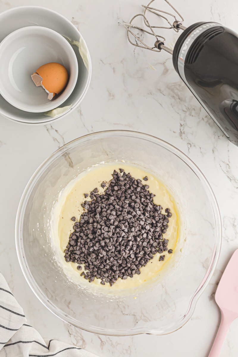 Adding chocolate chips to the cream cheese filling.