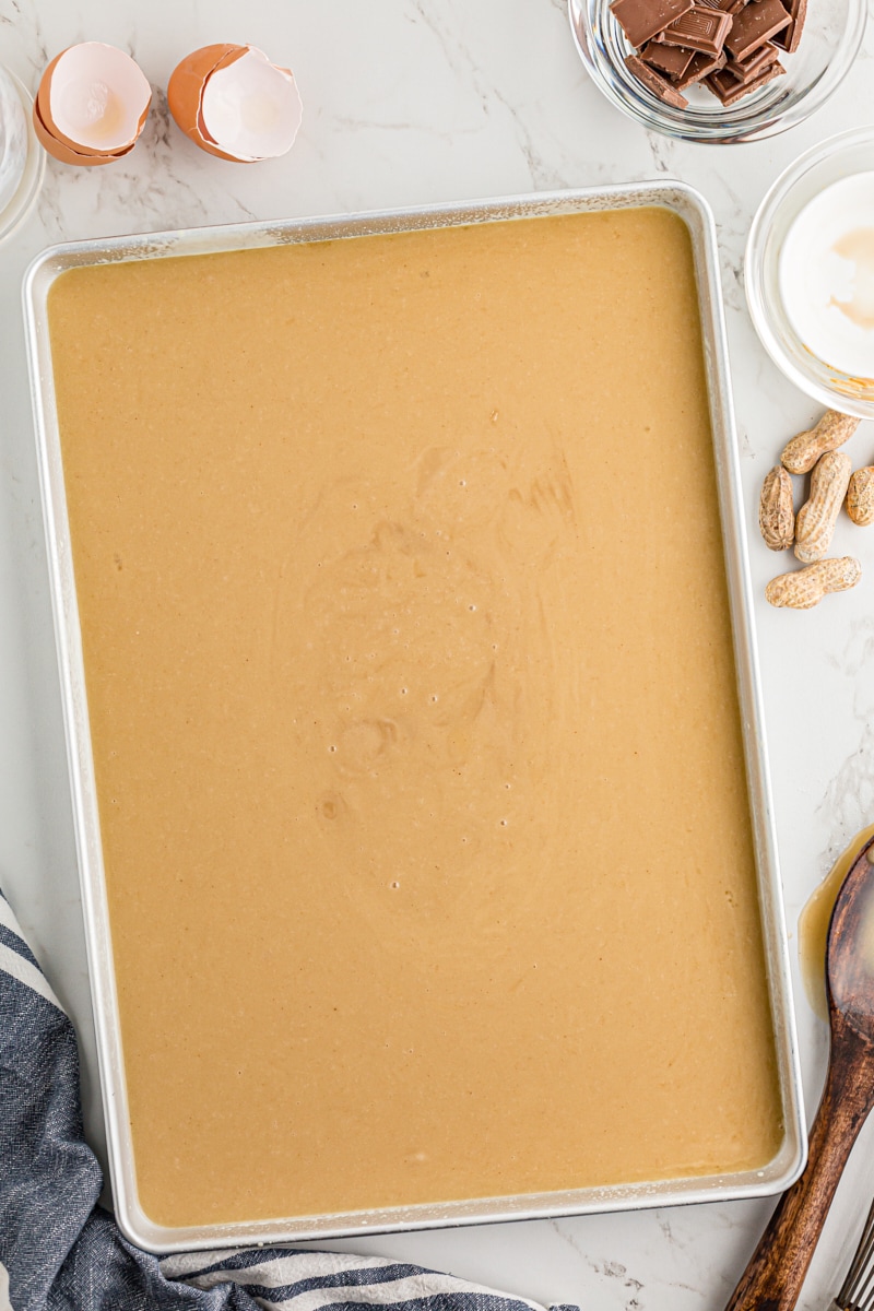 Peanut butter Texas sheet cake batter poured into the pan.