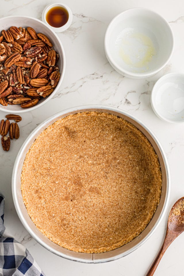 Pressing the crust into the springform pan.