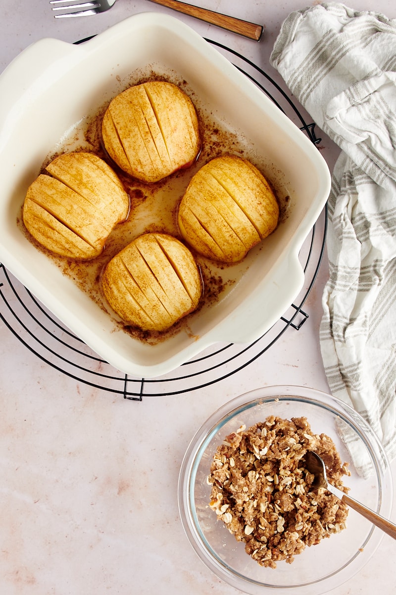 overhead view of partially baked apples in a baking dish