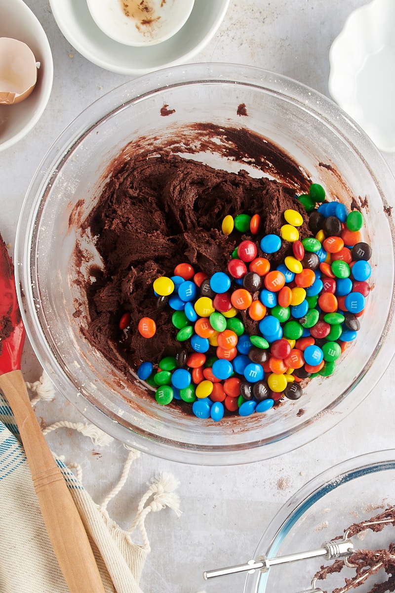 overhead view of M&Ms added to chocolate cookie dough
