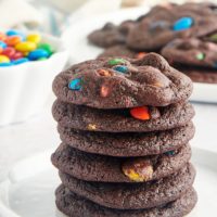 stack of Chocolate M&M Cookies on a white plate