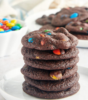 stack of Chocolate M&M Cookies on a white plate