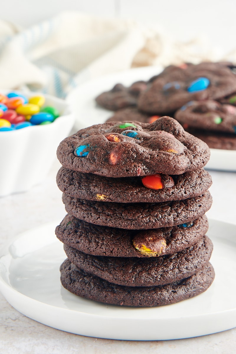 stack of Chocolate M&M Cookies on a white plate