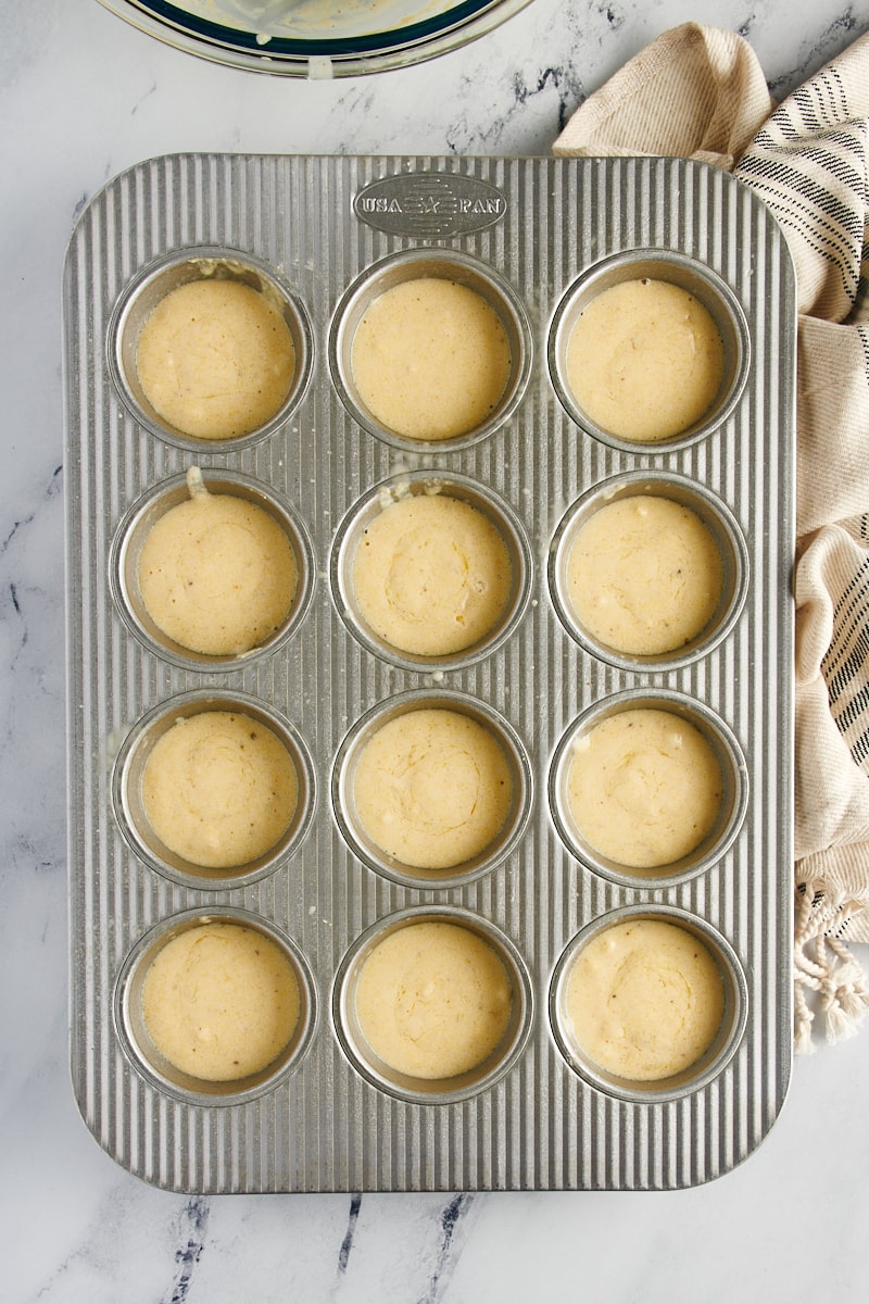 Muffin tin filled with corn muffin batter