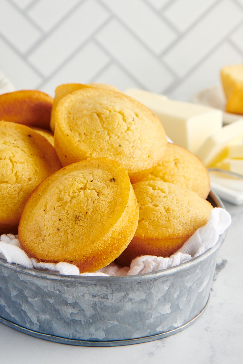 A metal basket filled with corn muffins