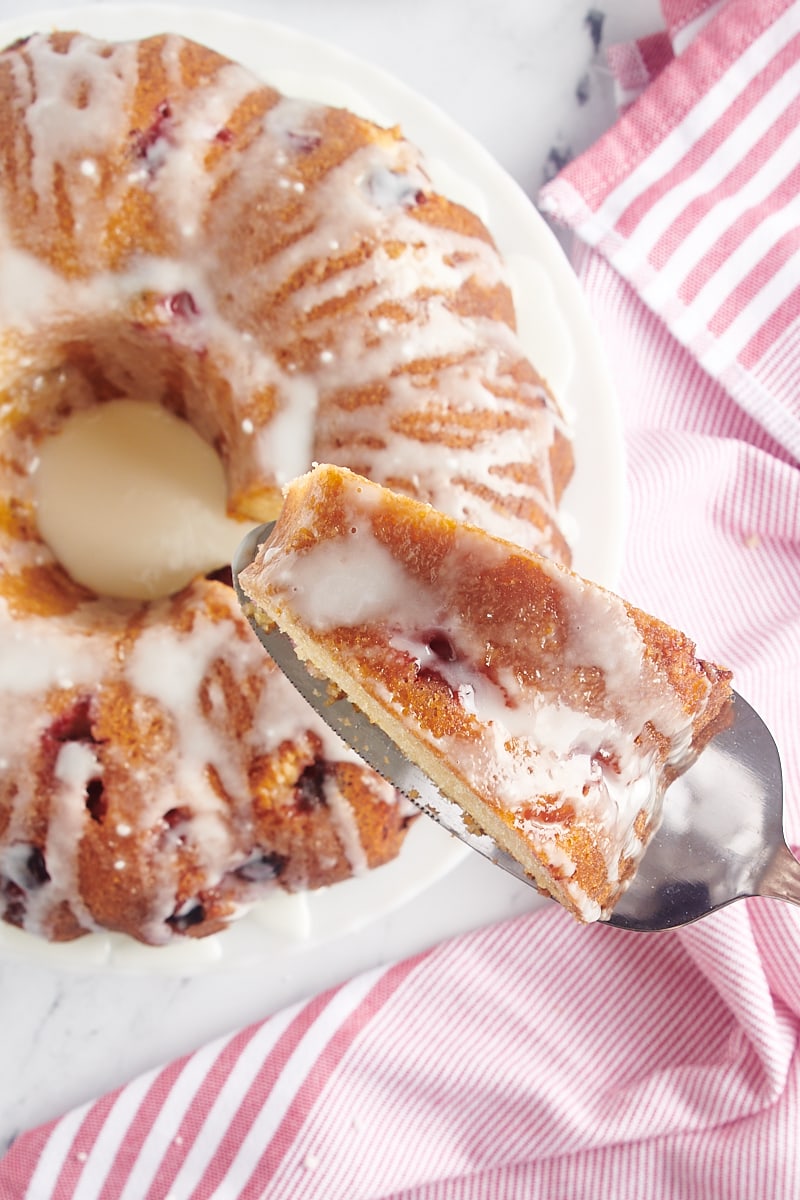 Taking a slice from cranberry bundt cake